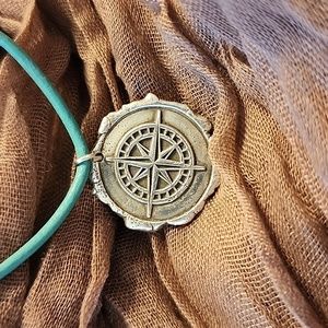 Sterling silver pendant on turquoise leather cord with sterling clasp.